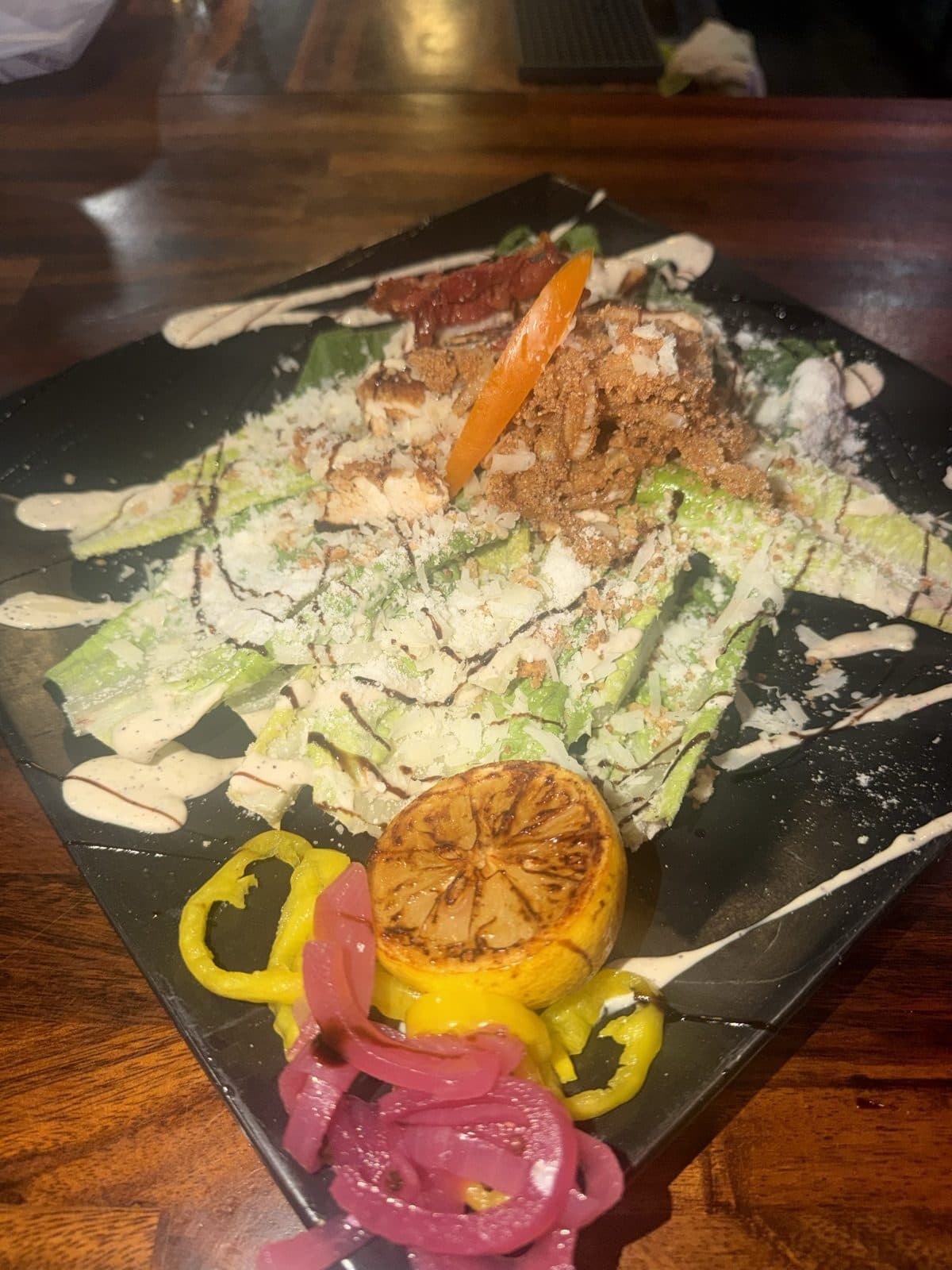 Sunday Caesar Wedge with romaine hearts, crispy prosciutto, garlic breadcrumbs, shaved pecorino Romano and grilled lemon