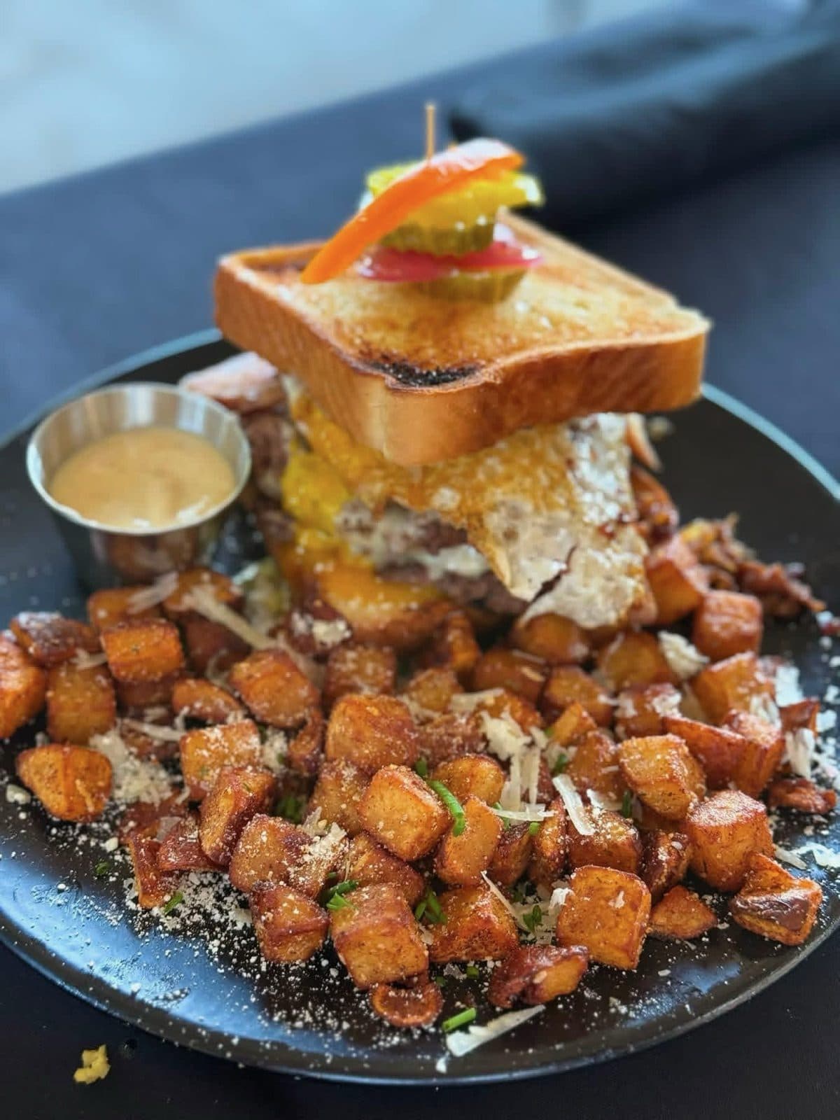 KB's Smash Brunch Burger with two smashed beef patties, American cheese, deli ham, bacon jam and a fried egg on a buttered brioche bun